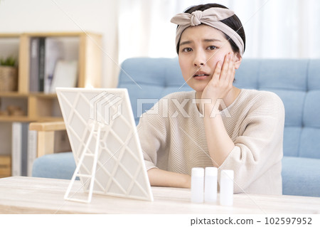 A young woman suffering from skin problems A young woman suffering from skin problems 102597952