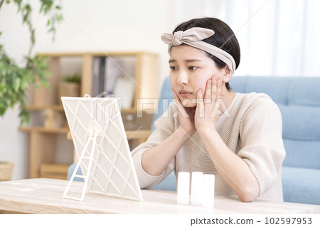 A young woman suffering from skin problems A young woman suffering from skin problems 102597953
