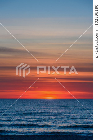 Spectacular bright golden sunset over Baltic sea Spectacular bright golden sunset over Baltic sea 102599190