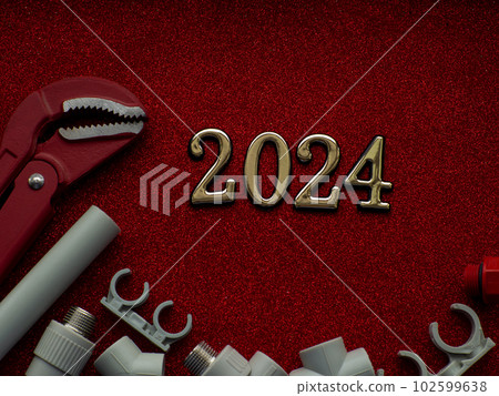 Construction tools and gift on red background 102599638
