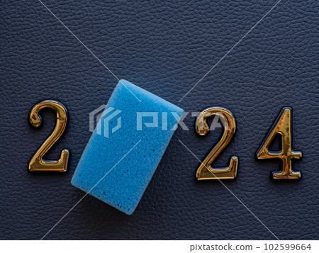 2024 and cleaning sponge instead zero on dark background 102599664