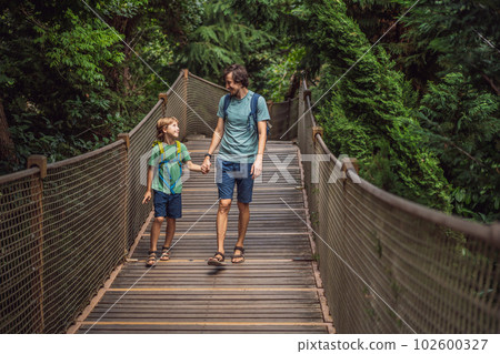 father and son tourists in Rope bridge in Yildiz Park. Besiktas, Istanbul, Turkey. Turkiye. Traveling with kids concept father and son tourists in Rope bridge in Yildiz Park. Besiktas, Istanbul, Turkey. Turkiye. Traveling with kids concept 102600327