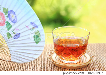 Drink barley tea and relax. Summer in Japan with fans and blinds 102600914