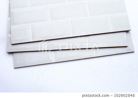Pile of wall tiles on white background. 102602848