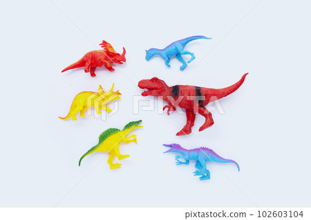 Plastic dinosaur toys on white background. Top view Plastic dinosaur toys on white background. Top view 102603104