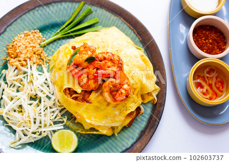 Prawn pad Thai noodles with egg wrap  Thailand street food 102603737