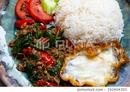 Rice with stir-fried beef and holy basil, fried egg. Rice with stir-fried beef and holy basil, fried egg. 102604303