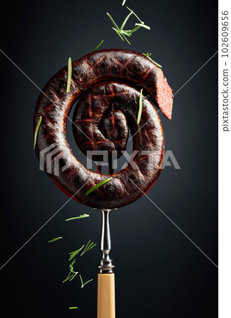 Spanish black pudding or blood sausage with rosemary on a fork. 102609656