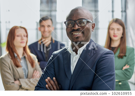 Successful trader. Modern young businessman in formal wear adjusting glasses looking at camera while standing in office 102610955