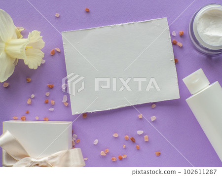 daffodils flower, bottle, gift box and paper card with copy space 102611287