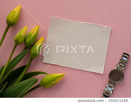 Womens wristwatch on pink background with tulip flowers and copy space Womens wristwatch on pink background with tulip flowers and copy space 102611288