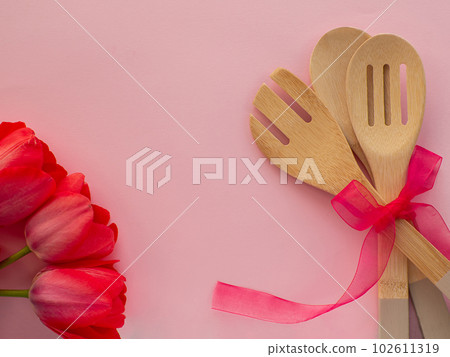 Tulips flowers with kitchen tools on background with copy space Tulips flowers with kitchen tools on background with copy space 102611319