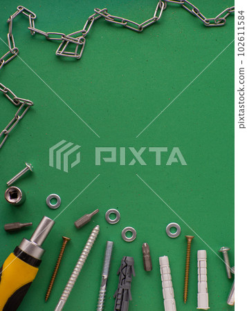 Green background with metal chain and tools 102611584