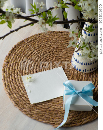 cherry flowers in vase gift box with blue bow and paper card with copy space cherry flowers in vase gift box with blue bow and paper card with copy space 102611600