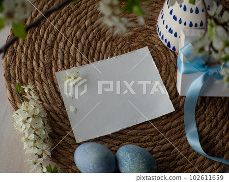 cherry flowers in vase, gift box with blue bow and paper card with copy space cherry flowers in vase, gift box with blue bow and paper card with copy space 102611659