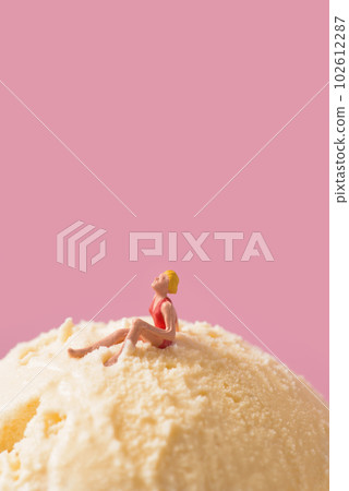 miniature woman in swimsuit on a vanilla ice cream 102612287