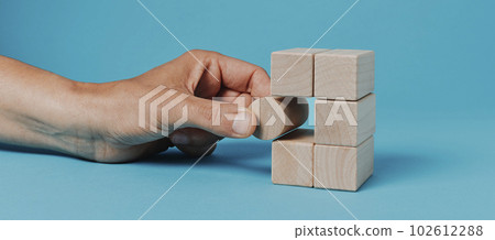 man playing with building blocks, banner format 102612288