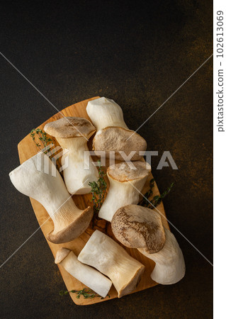 Eryngii mushrooms on a cutting board Eryngii mushrooms on a cutting board 102613069