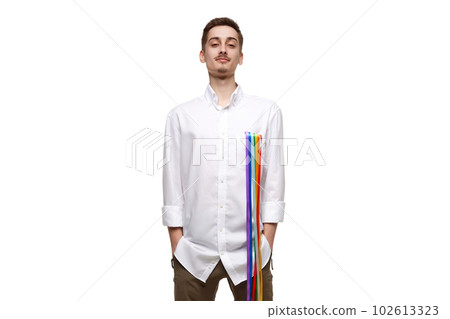 Portrait of young man posing in white shirt with rainbow, lgbt flag against white background. Relationship freedom 102613323