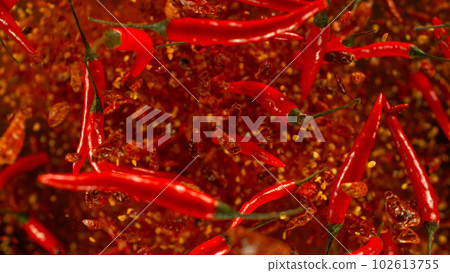 Chilli peppers flying up in the air. Freeze motion. Isolated on black background. 102613755