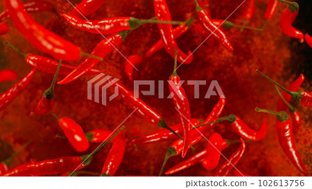 Chilli peppers flying up in the air. Freeze motion. Isolated on black background. Chilli peppers flying up in the air. Freeze motion. Isolated on black background. 102613756