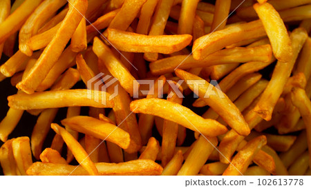 Freeze Motion Shot of Flying Fresh French Fries, Close-up 102613778