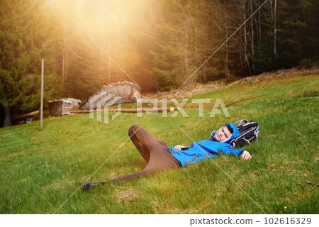 Hikers lie down taking resting after long walk at top of mountain. Tourist lies on top of the mountain and see the view. 102616329