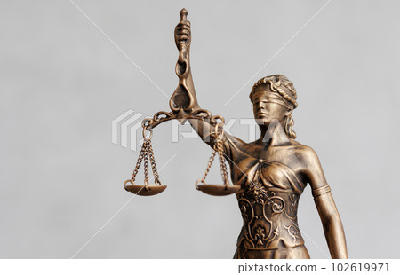 close up, themis is goddess of justice statuette on dark background. symbol of law with scales  102619971