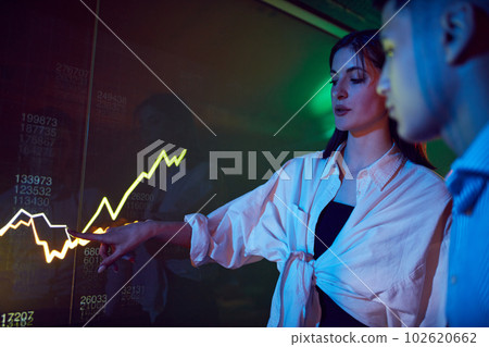 Colleagues at business meeting, conference making professional presentation, showing graphs on digital screen. Trade market 102620662