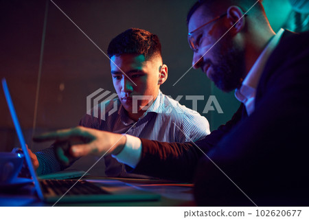 Close-up of two people, businessman showing trainee information on atop. Employment. Modern office Close-up of two people, businessman showing trainee information on atop. Employment. Modern office 102620677