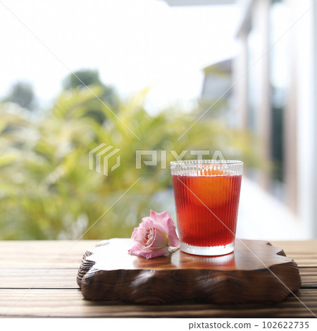 Rosella Juice in a glass cup on wooden tray 102622735