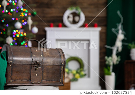 A large decorative old chest in brown stands in the foreground. 102627554