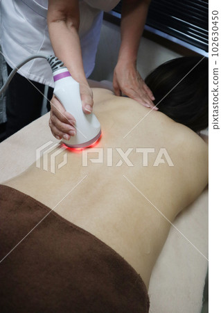 A woman who receives a treatment at an esthetic salon A woman who receives a treatment at an esthetic salon 102630450