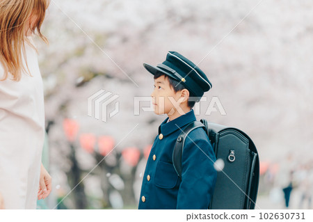 A new first grader who gets his mother to put a hat on 102630731