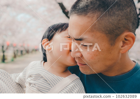 Dad holding a child in a cherry blossom bag 102632089