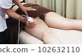 A woman who receives a treatment at an esthetic salon 102632110
