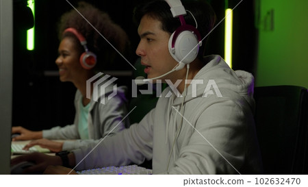 Game streamer using pc setup playing multiplayer first person shooter Game streamer using pc setup playing multiplayer first person shooter 102632470
