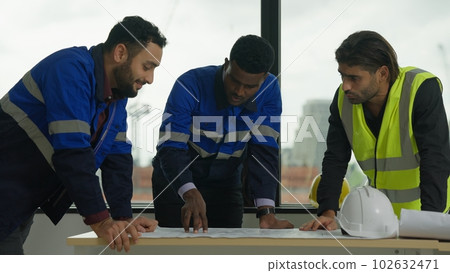 Construction engineers team using blueprint of project plan brainstorming Construction engineers team using blueprint of project plan brainstorming 102632471