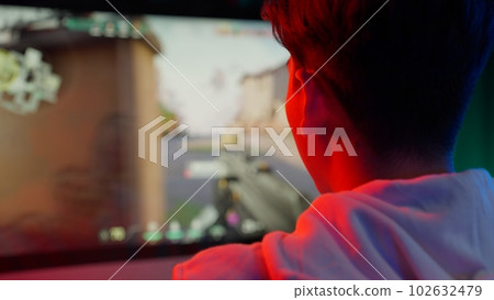 Game streamer using pc setup playing multiplayer first person shooter Game streamer using pc setup playing multiplayer first person shooter 102632479