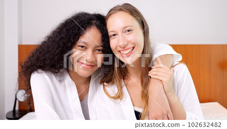 Cheerful close friends women expressing positive emotions to camera Cheerful close friends women expressing positive emotions to camera 102632482