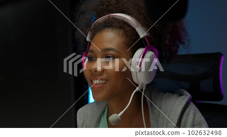 Game streamer using pc setup playing multiplayer first person shooter 102632498