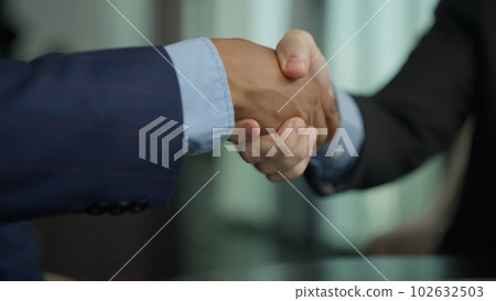 Business people shacking hands together showing successful contract agreement 102632503