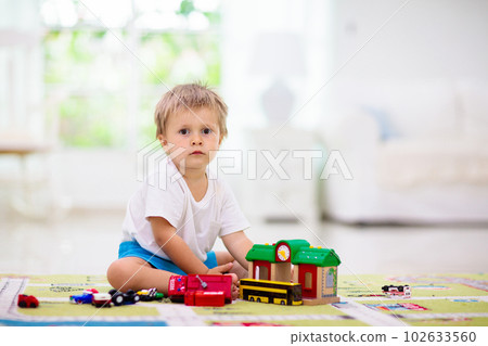 Boy playing toy cars. Kid with toys. Child and car Boy playing toy cars. Kid with toys. Child and car 102633560