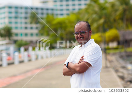 Young man walking in yacht club resort. 102633802