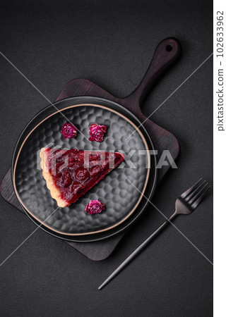 Delicious fragrant sweet pie with cherry berries on a ceramic plate 102633962