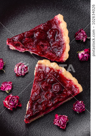 Delicious fragrant sweet pie with cherry berries on a ceramic plate Delicious fragrant sweet pie with cherry berries on a ceramic plate 102634026