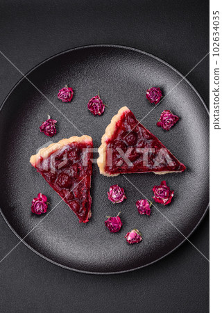 Delicious fragrant sweet pie with cherry berries on a ceramic plate Delicious fragrant sweet pie with cherry berries on a ceramic plate 102634035