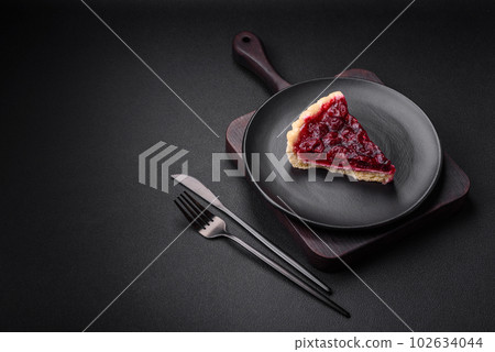 Delicious fragrant sweet pie with cherry berries on a ceramic plate Delicious fragrant sweet pie with cherry berries on a ceramic plate 102634044