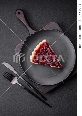 Delicious fragrant sweet pie with cherry berries on a ceramic plate 102634045