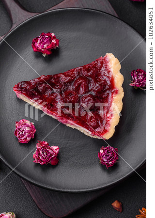 Delicious fragrant sweet pie with cherry berries on a ceramic plate 102634051